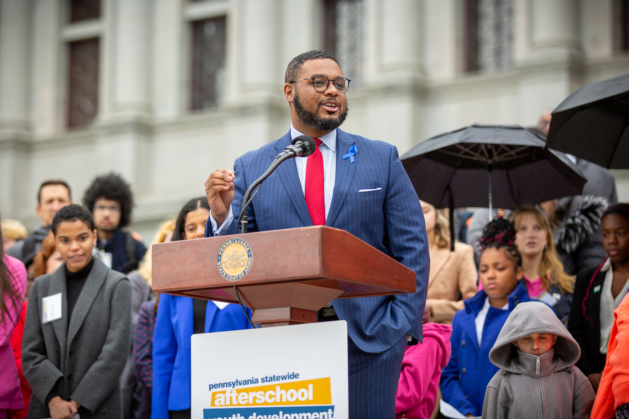 Lieutenant Governor Austin Davis smiling and speaking to attendees on Capitol steps during 2023 Afterschool Advocacy Rally